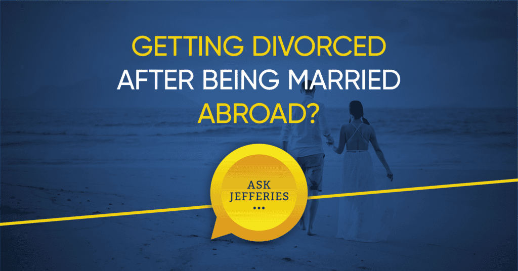 Getting divorced after being married abroad. Two people hand in hand on a beach